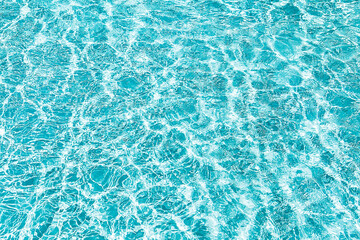 Blue transparent water with flecks of sunshine