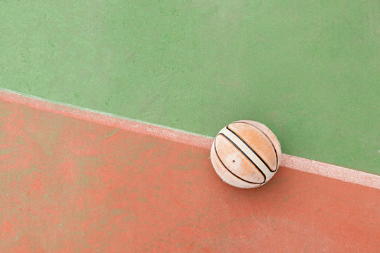 Close-up of a basketball placed on a court seen from above