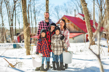 family close to a maple shack having fun together - 777684671