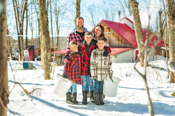 family close to a maple shack having fun together - 777684673