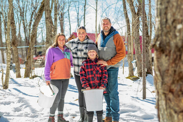 family close to a maple shack having fun together - 777685201