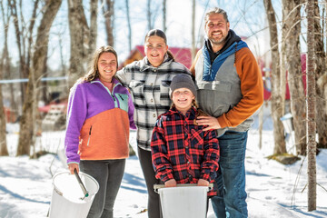 family close to a maple shack having fun together - 777685225