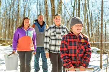 family close to a maple shack having fun together - 777685265