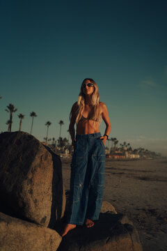 Stylish woman on the beach with trendy clothes 