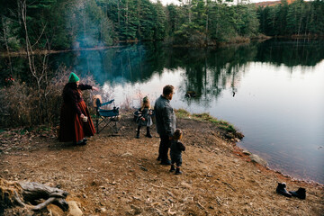 family by a lake at sunset in a remote area 