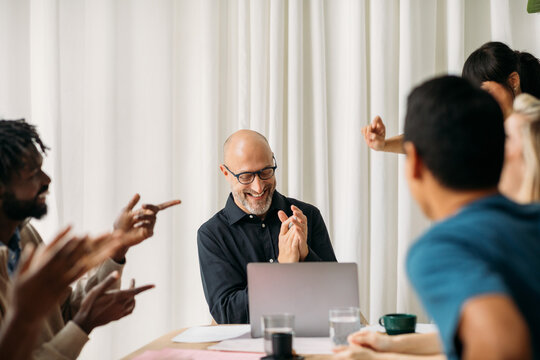 Coworkers applauding in office