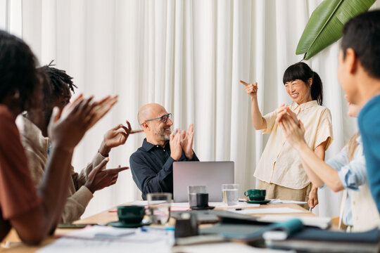 Coworkers applauding in office