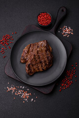 Fresh juicy delicious beef steak on a dark background