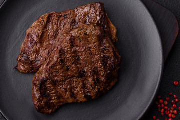 Fresh juicy delicious beef steak on a dark background