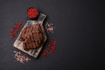 Fresh juicy delicious beef steak on a dark background