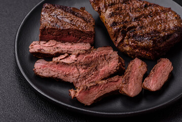 Fresh juicy delicious beef steak on a dark background