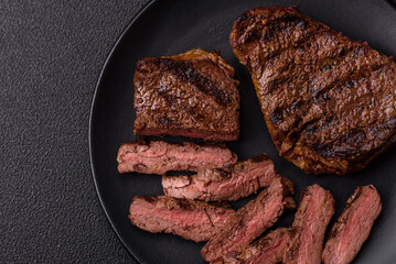 Fresh juicy delicious beef steak on a dark background