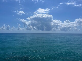 Sea blue shiny water and amazing sky clouds.