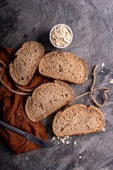 Fresh slices of home baked artisan sourdough bread on white rustic dark background. german rye bread