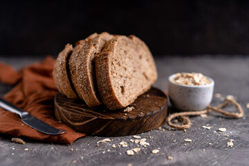 Fresh slices of home baked artisan sourdough bread on white rustic dark background. german rye bread