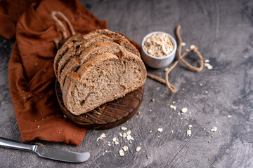 Fresh slices of home baked artisan sourdough bread on white rustic dark background. german rye bread