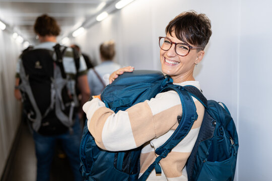 Traveler woman boarding airplane.