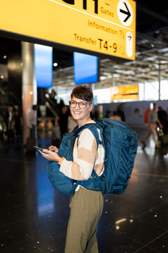 Smiling female traveler at the airport.