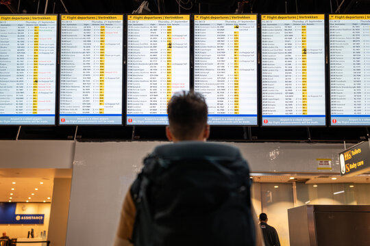 Traveler woman checking flight schedule.
