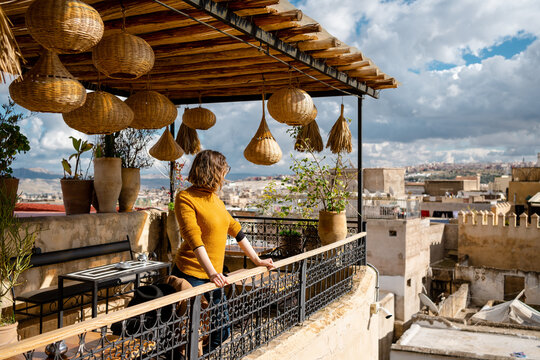 A woman looking at the view from the terrace of a bar
