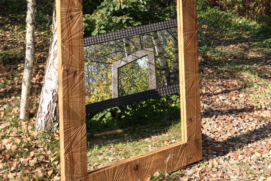 Infinite mirror reflecting mirror surrounded by trees and nature