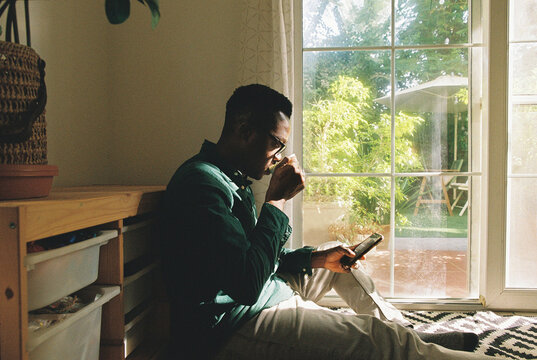 A man with a mobile phone indoors