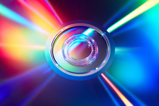 Dynamic display of compact CD disc reflecting multicolor light - Powered by Adobe