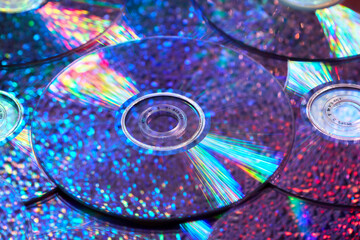 Trendy pattern of CD discs with iridescent light and water droplets