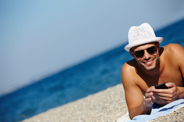Man, beach and smartphone in portrait on holiday with ocean on seashore with blue sky in summer for...