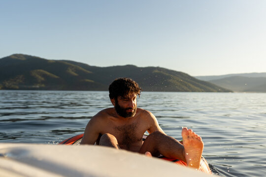 A men on a tube at lake Eildon