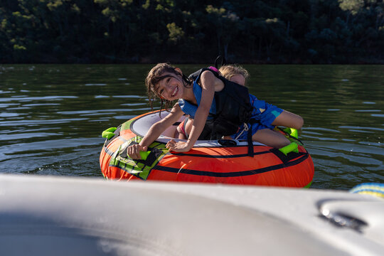 Kids playing on a tube at lake Eildon