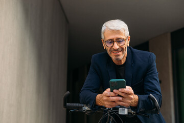 Senior man using mobile phone outside