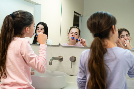 sisters kids girls brushing teeth before bedtime