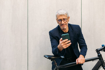 Senior man using smartphone outside