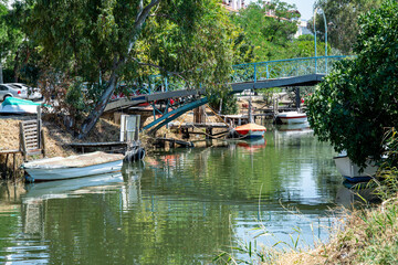 Old wooden fishing boats on a calm river. Boat moored in a canal on a sunny summer day. Fishing boats on the river in autumn
