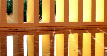 Architecture orange patterns pillars reflected on water surface