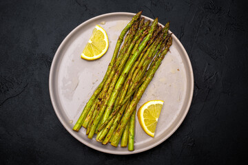 Fresh green asparagus on the black background