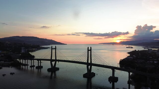 Aerial View of Iconic Merah Putih Cable Stayed Bridge accross Ambon Bay and Wai Ruhu Galala Yellow Truss Bridge. 
