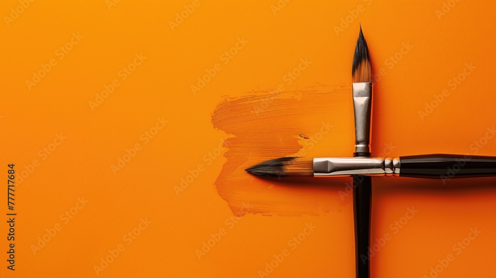 Poster two paintbrushes with bristles facing different directions on orange background stroke of paint link