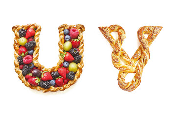 Sweet Letters "U" and "V" Made of Fruit Pie and Pretzel Isolated on White Background