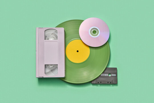 Stack of old audio cassette, CD disc, videotape and vinyl plate