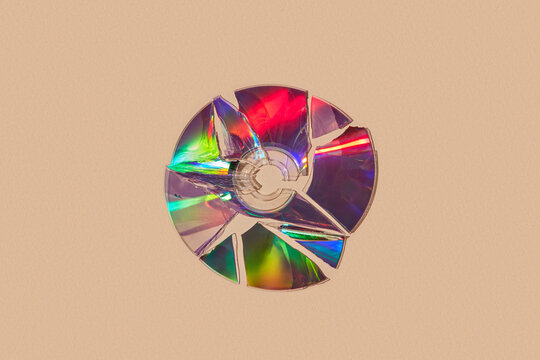 Vibrant rainbow light on top of cracked compact disk