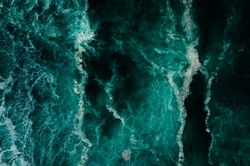Top down aerial view of moody ocean wave