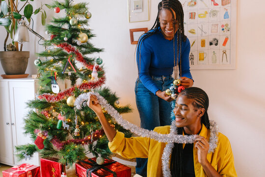 Roommates having fun with Christmas decorations