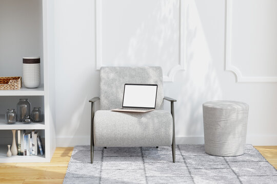 Laptop with empty screen on chair in sunlit living room. Mock up