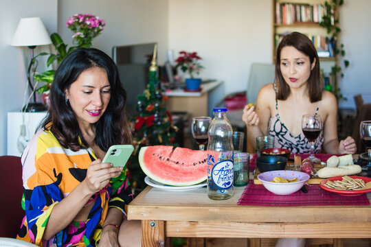 Phone interrupting dinner with friends