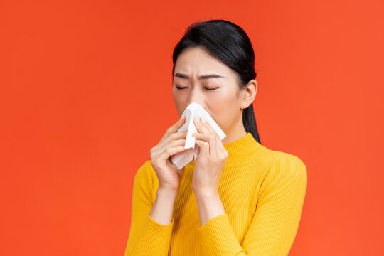 girl with closed eyes holding hands a handkerchief near the nose