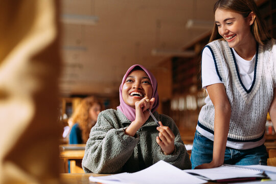 Happy students in library 