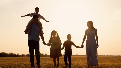 happy family child kid baby together teamwork dream fly children's dream silhouette sunset field...