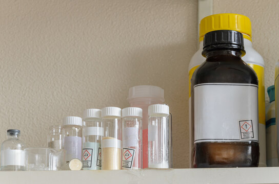 Shelf filled with various chemical bottles. Mockup.